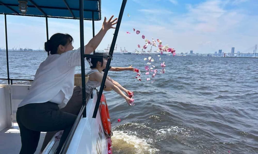 横浜・ベイブリッジ沖の海洋散骨で、船上から花を手向けて故人を見送るご家族の様子